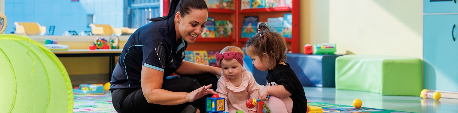 Creche staff caring for young children